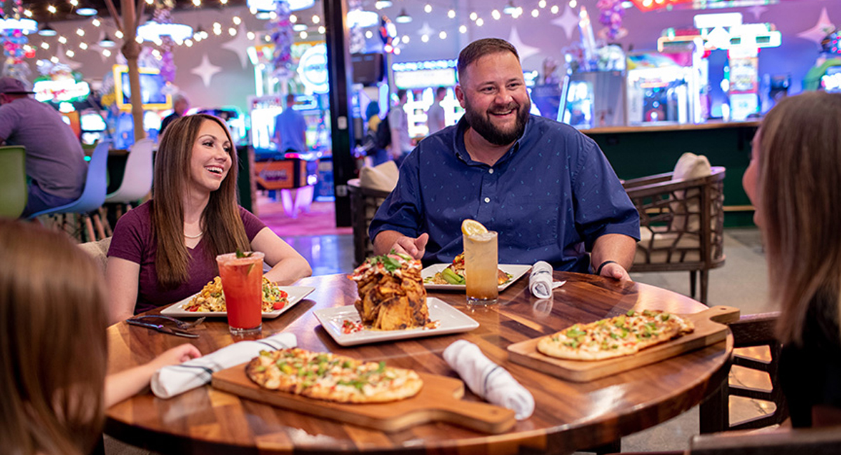 family enjoying food and entertainment at Downtown Flavortown in Pigeon Forge TN