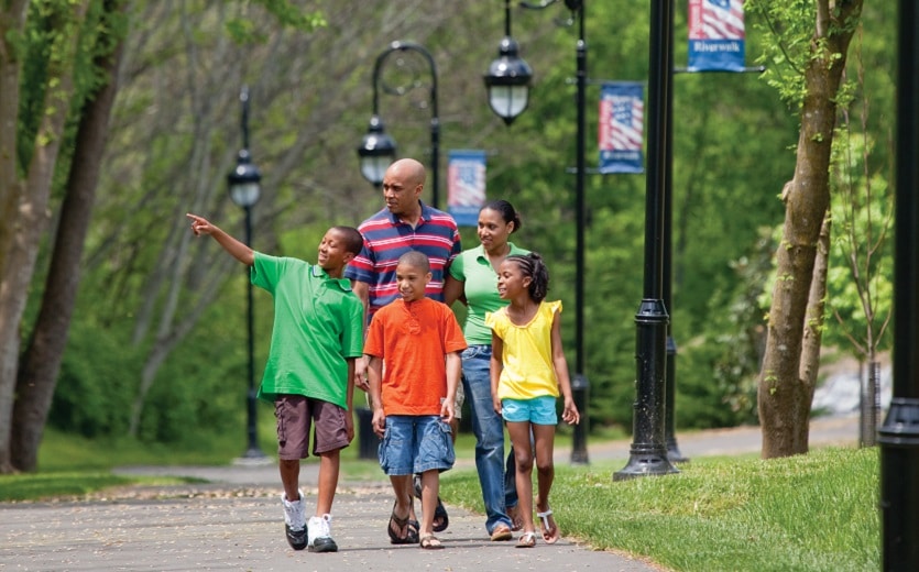 Family walking along Riverwalk Trail in Pigeon Forge, TN