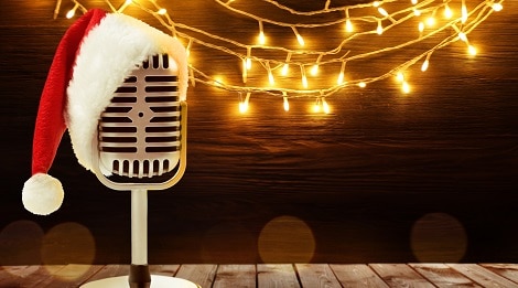 microphone with santa hat on stage in front of lights