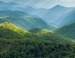 smoky mountains day light shining on green hills