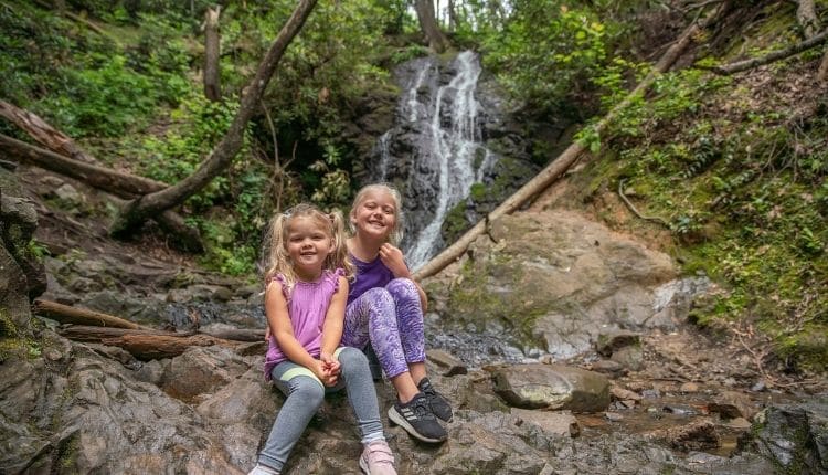 Kids posing in front of Smoky Mountain waterfall