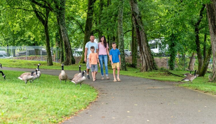 Family strolling the Riverwalk trail in Pigeon Forge during Spring Break