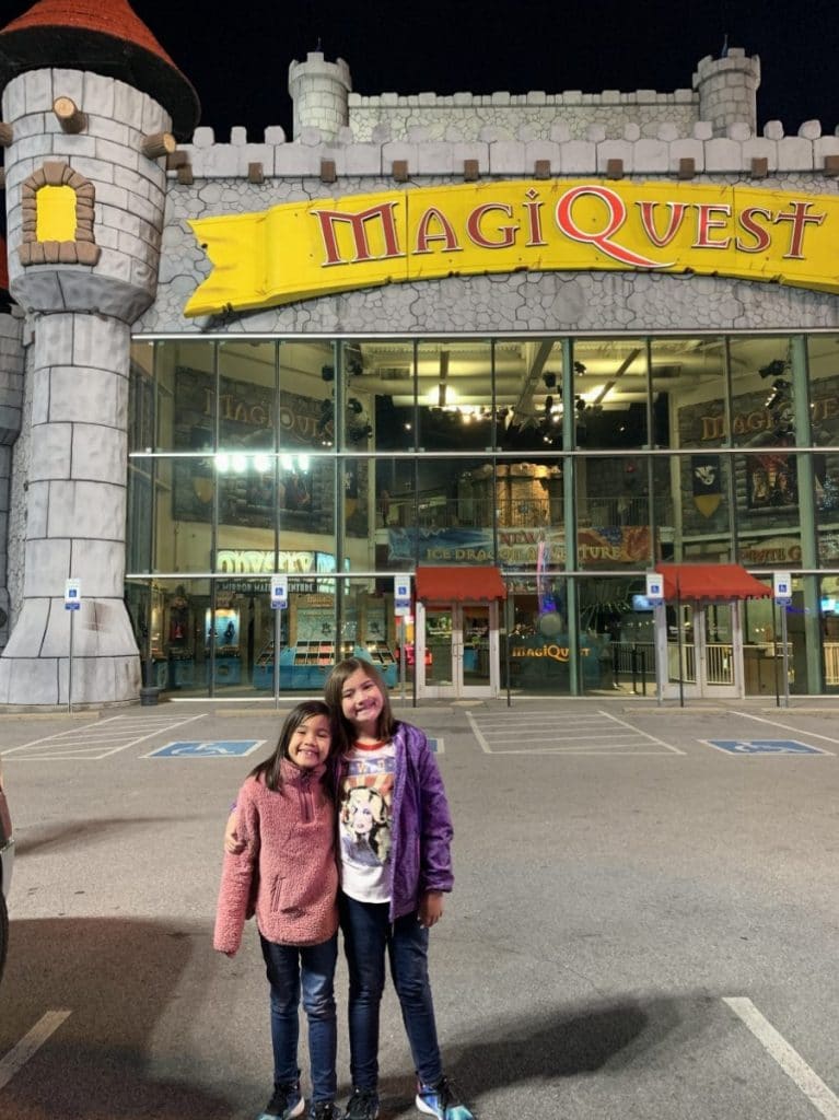 Girls posing in front of MagiQuest in Pigeon Forge TN 