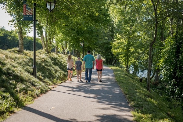 Family walking on the Riverwalk Trail in Pigeon Forge, TN