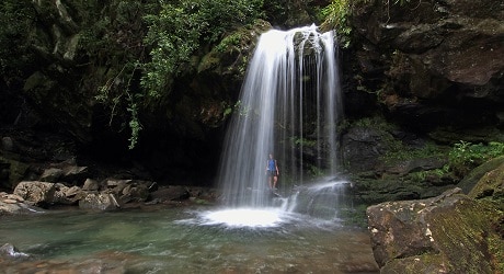 Woman behind Grotto Falls in the Great Smoky Mountains