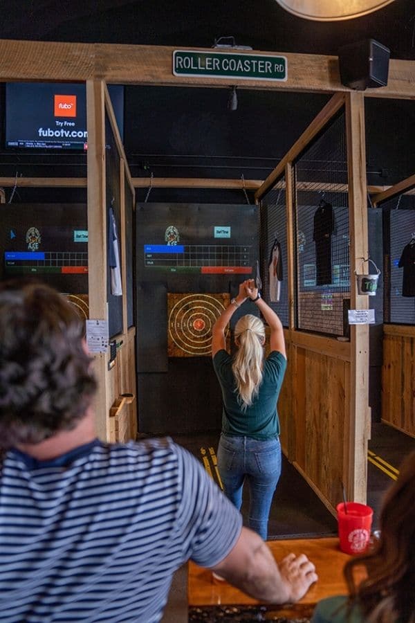 Couple throwing axes at Country Roads Axe Co