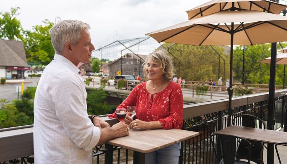 Couple sipping wine on the patio of Mill Bridge Winery