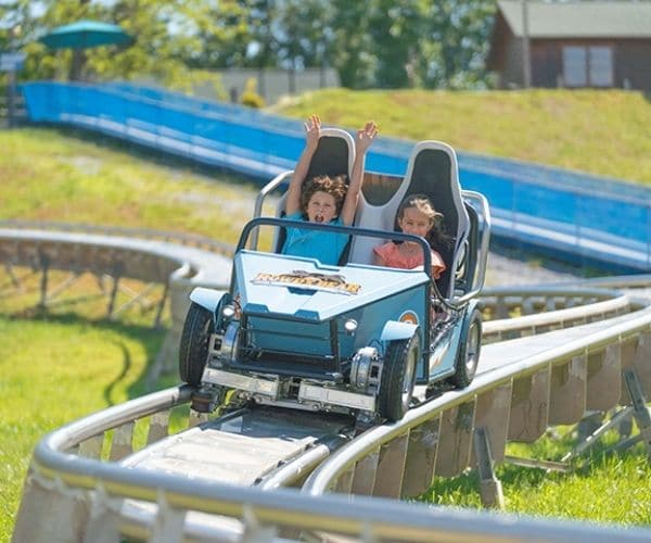 Kids riding power coaster at Rowdy Bear Ridge