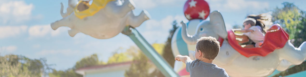 child pointing at attraction