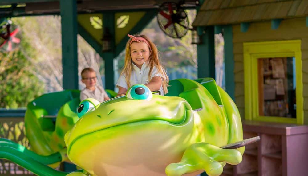 little girl on the Frogs & Fireflies ride at Pigeon Forge