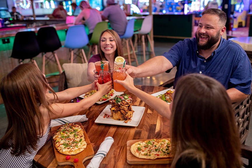 visitors drinking and eating at Downtown Flavortown in Pigeon Forge