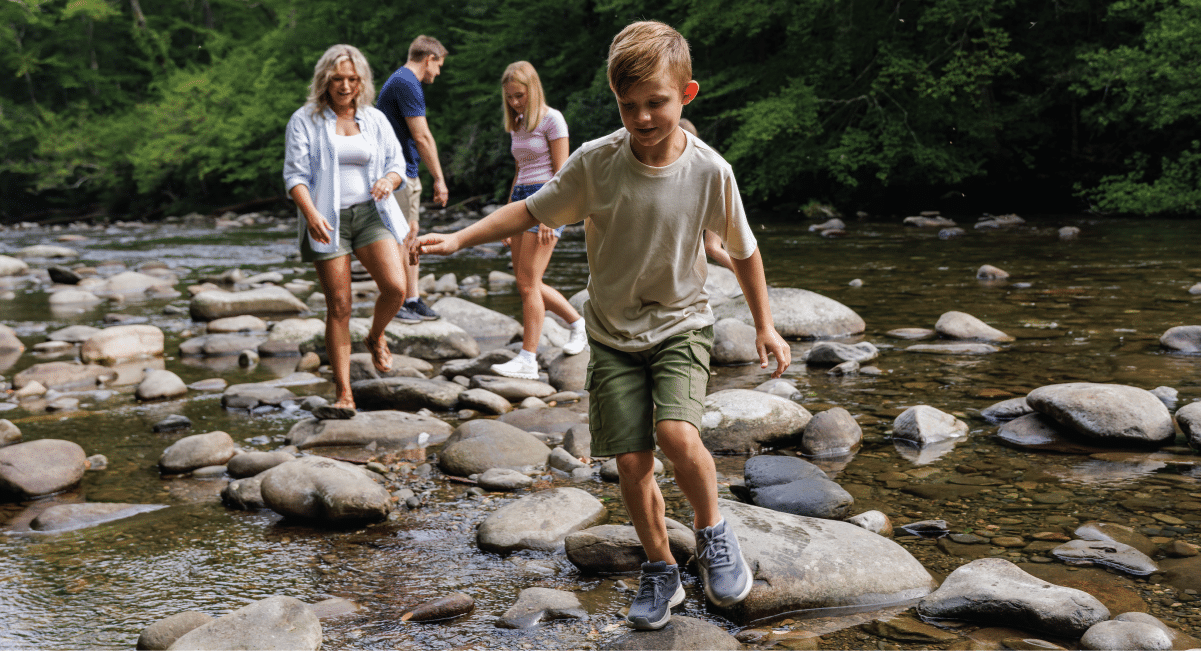 image of family exploring a river at the Smokies