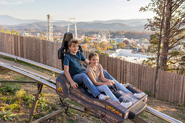 family riding an alpine coaster in fall in pigeon forge tn